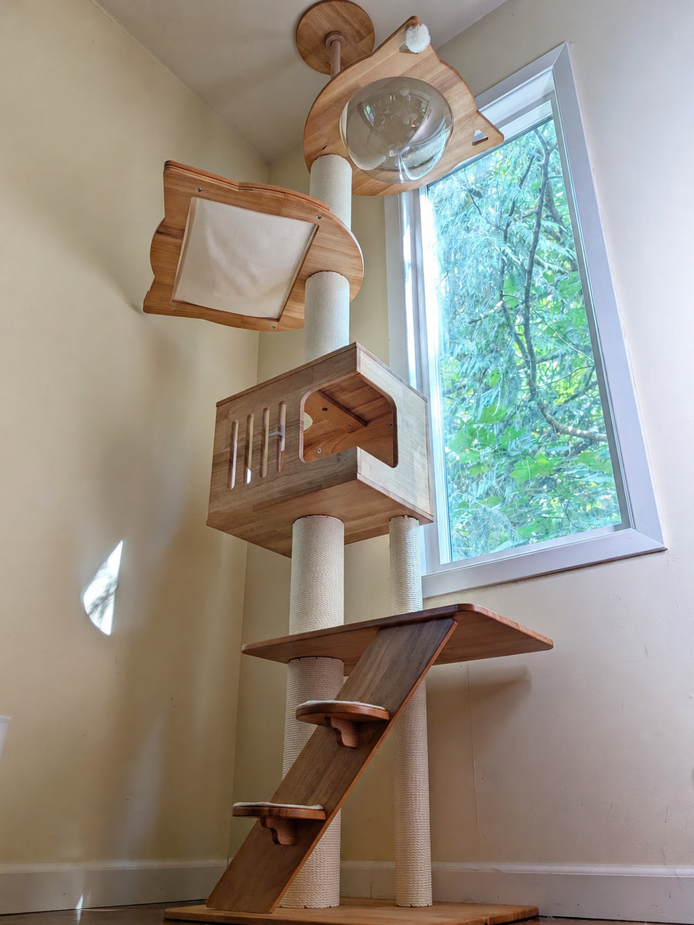A wooden cat tree by a window
